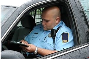 Police officer writing a speeding ticket